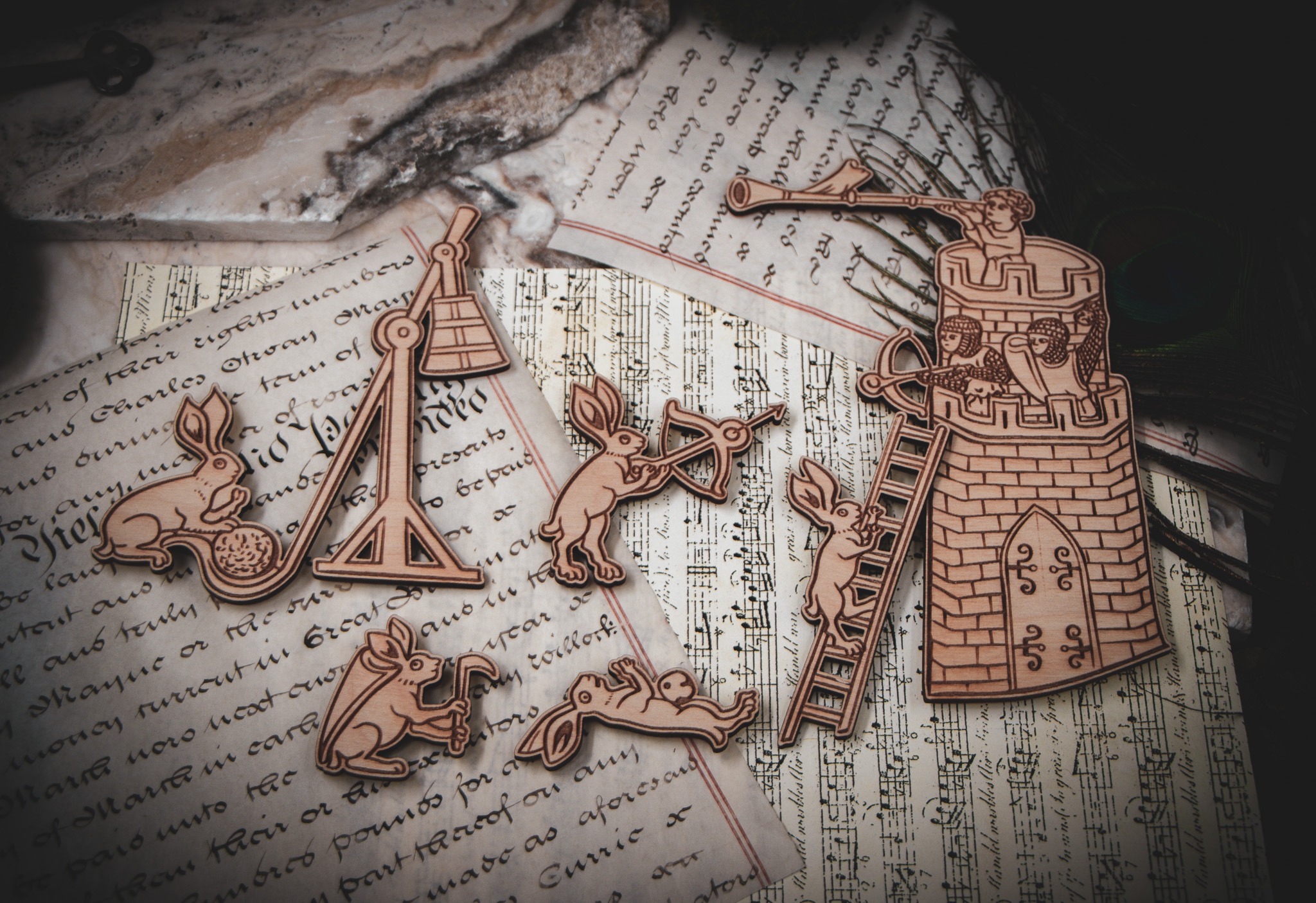 A laser cut and engraved magnet made from raw birch plywood in the shape of a satyr holding a branch from the Aberdeen Bestiary leaning against an open book.