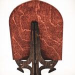 The back view of a handcrafted birch plywood library sign, showing the dark-stained wooden stand and natural wood grain.