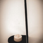 The side of an architectural book nook lantern featuring laser-cut Gothic cathedral window tracery made from 1/8 inch birch plywood painted matte black