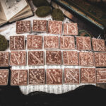 Square birch wood magnets featuring Hans Holbein the Younger's Danse Macabre alphabet woodcuts from 1523.