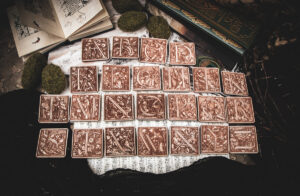 Square birch wood magnets featuring Hans Holbein the Younger's Danse Macabre alphabet woodcuts from 1523.