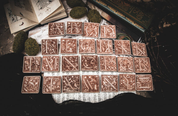 Square birch wood magnets featuring Hans Holbein the Younger's Danse Macabre alphabet woodcuts from 1523.