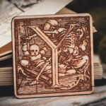 Square birch wood magnet featuring Hans Holbein the Younger's Danse Macabre alphabet letter Y woodcut from 1523.