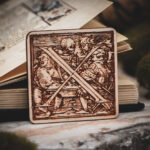 Square birch wood magnet featuring Hans Holbein the Younger's Danse Macabre alphabet letter X woodcut from 1523.