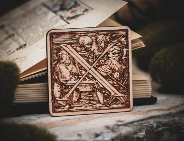 Square birch wood magnet featuring Hans Holbein the Younger's Danse Macabre alphabet letter X woodcut from 1523.