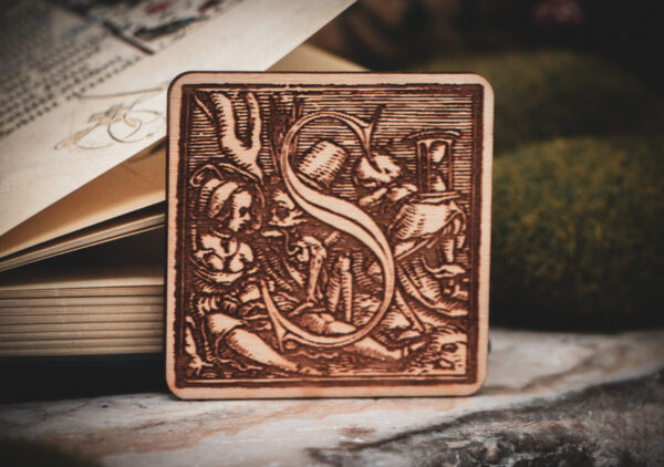 Square birch wood magnet featuring Hans Holbein the Younger's Danse Macabre alphabet letter S woodcut from 1523.