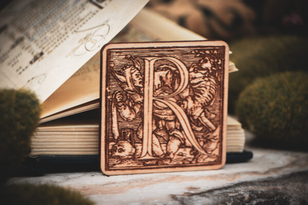 Square birch wood magnet featuring Hans Holbein the Younger's Danse Macabre alphabet letter R woodcut from 1523.