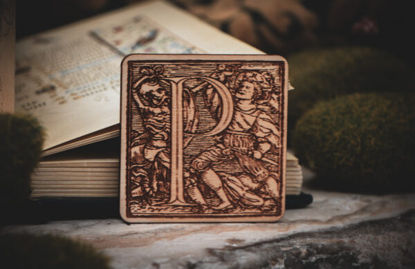 Square birch wood magnet featuring Hans Holbein the Younger's Danse Macabre alphabet letter P woodcut from 1523.