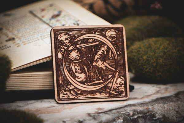 Square birch wood magnet featuring Hans Holbein the Younger's Danse Macabre alphabet letter O woodcut from 1523.