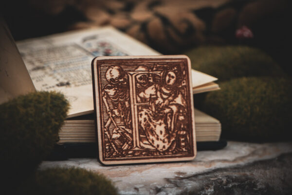 Square birch wood magnet featuring Hans Holbein the Younger's Danse Macabre alphabet letter F woodcut from 1523.