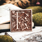 Square birch wood magnet featuring Hans Holbein the Younger's Danse Macabre alphabet letter E woodcut from 1523.