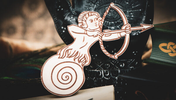 A close-up of the Slow-Shot Sentinel magnet made of laser cut and engraved raw birch plywood in the shape of a man with a snail shell for legs aiming a bow and arrow.