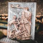 A set of six laser cut and engraved birch magnets featuring rabbits waging battle against knights in a castle tower in a cellophane bag with a gray card of a medieval woodcut print leaning against a stack of books.