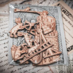 A set of six laser cut and engraved birch magnets featuring rabbits waging battle against knights in a castle tower in a cellophane bag with a gray card of a medieval woodcut print on top of various papers and a stone surface.