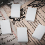 Set of 5 3D printed mini book blanks arranged in a group on top of various papers and a stone surface seen from above