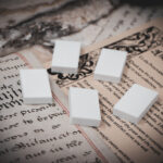 Set of 5 3D printed mini book blanks arranged in a group on top of various papers and a stone surface seen from a slight angle