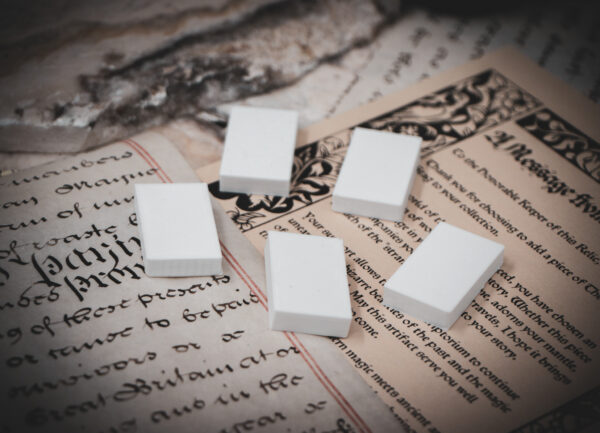 Set of 5 3D printed mini book blanks arranged in a group on top of various papers and a stone surface seen from a slight angle